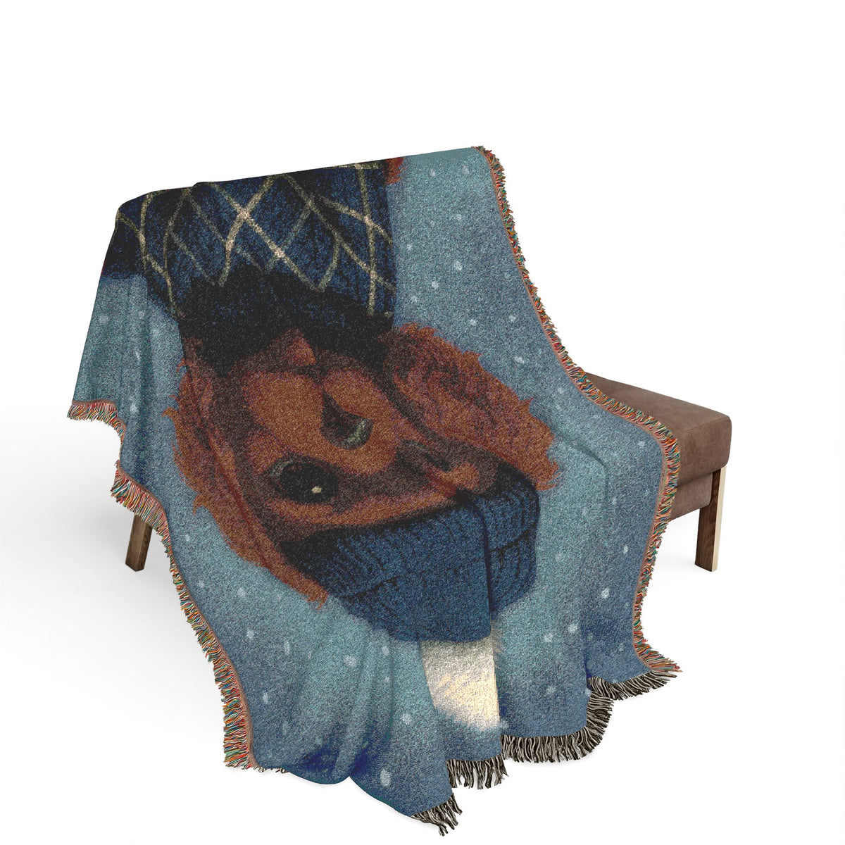 Ruby Cavalier woven cotton blanket draped over a brown armchair, close view of the design and fringe
