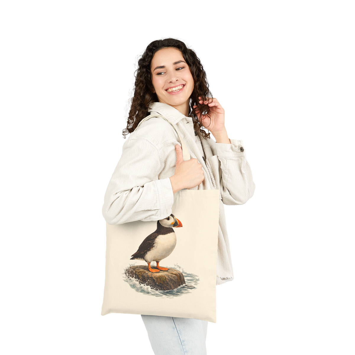 Woman carrying the Coastal Puffin natural canvas tote bag over her shoulder