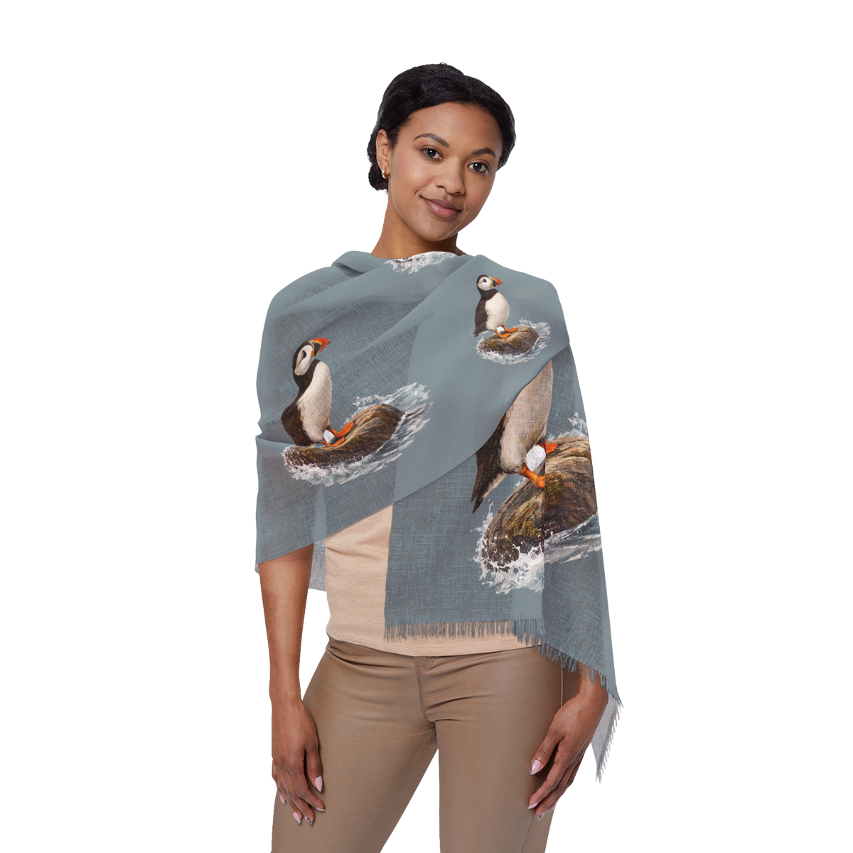 Woman wearing the Bram slate blue wrap scarf printed with puffins on coastal rocks