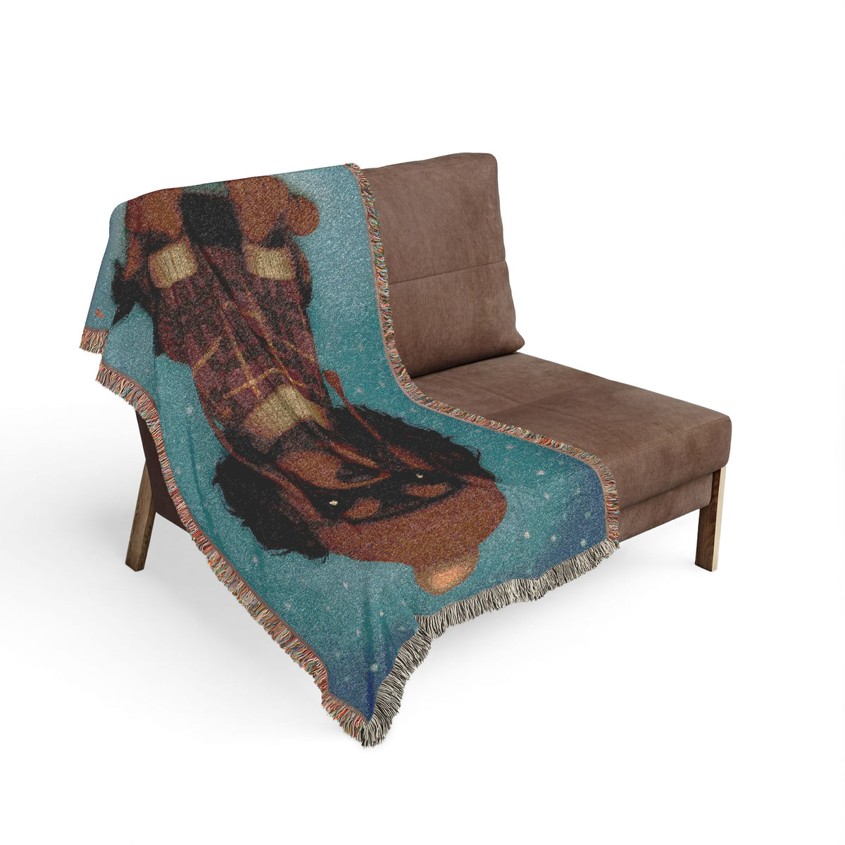 Black and Tan Cavalier woven cotton blanket draped over a brown armchair in a living room